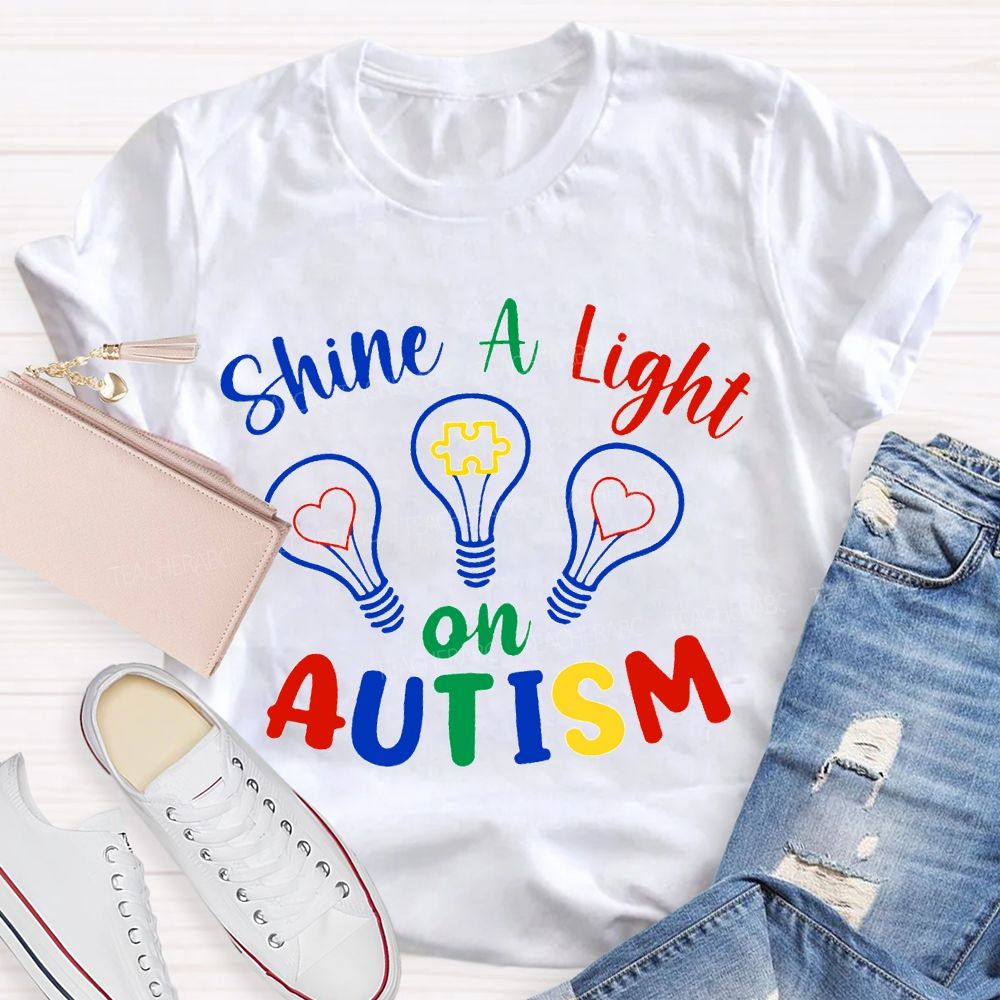 Shine A Light Autism Colored Lettering And Light Bulbs T-shirt