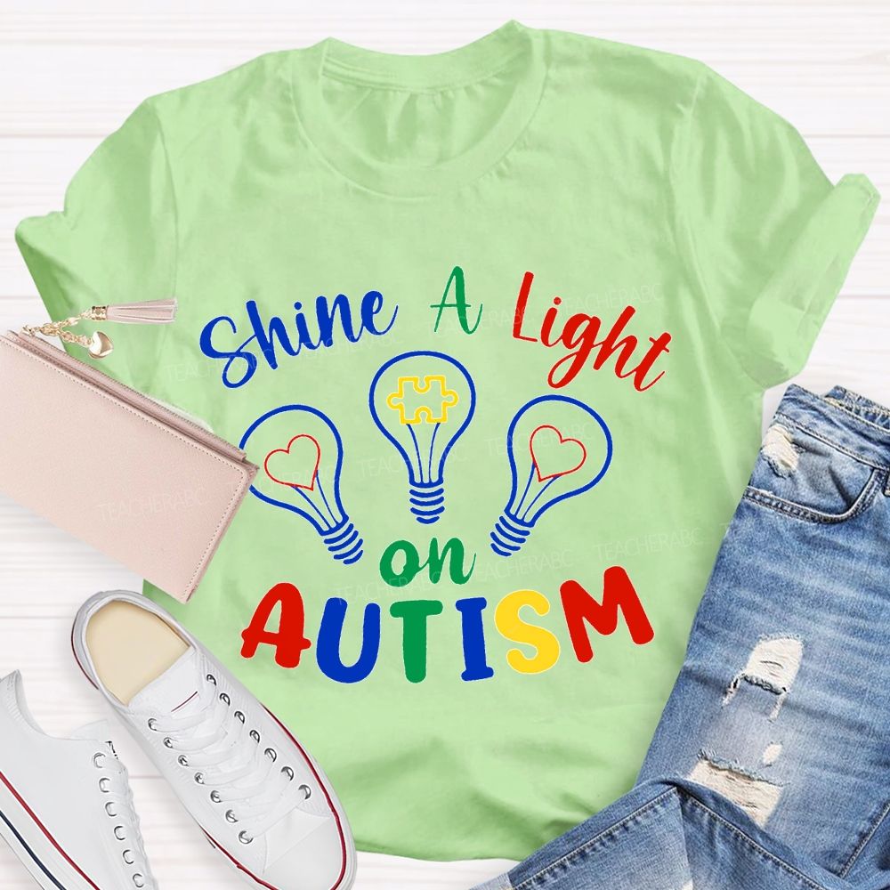 Shine A Light Autism Colored Lettering And Light Bulbs T-shirt