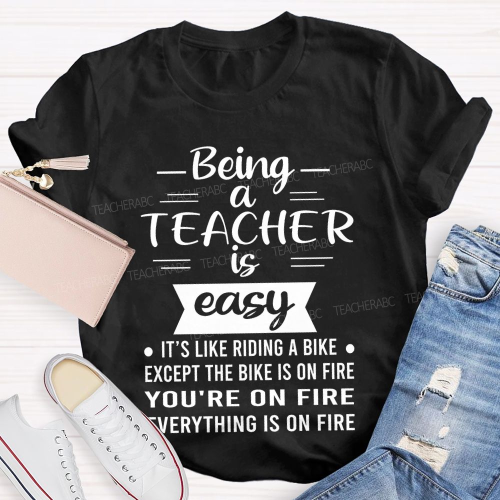 Being A Teacher Is Easy It's Like Riding A Bike Except The Bike Is On Fire Teacher T-shirt