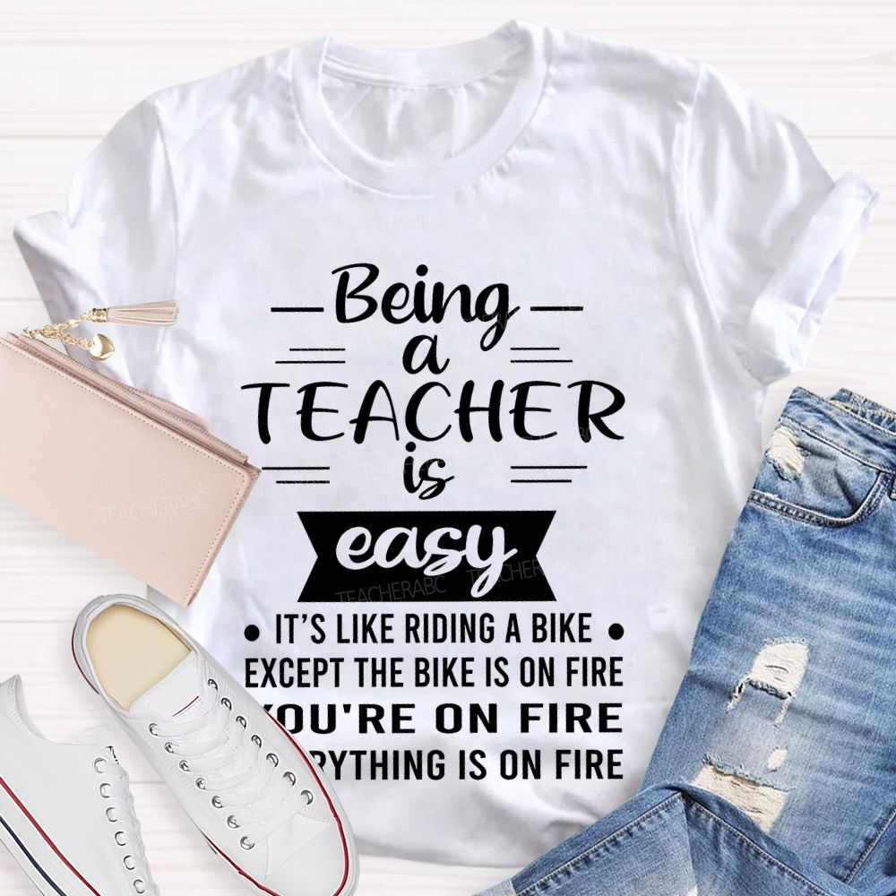 Being A Teacher Is Easy It's Like Riding A Bike Except The Bike Is On Fire Teacher T-shirt