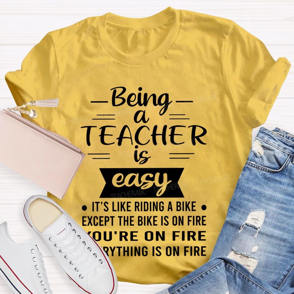 Being A Teacher Is Easy It's Like Riding A Bike Except The Bike Is On Fire Teacher T-shirt