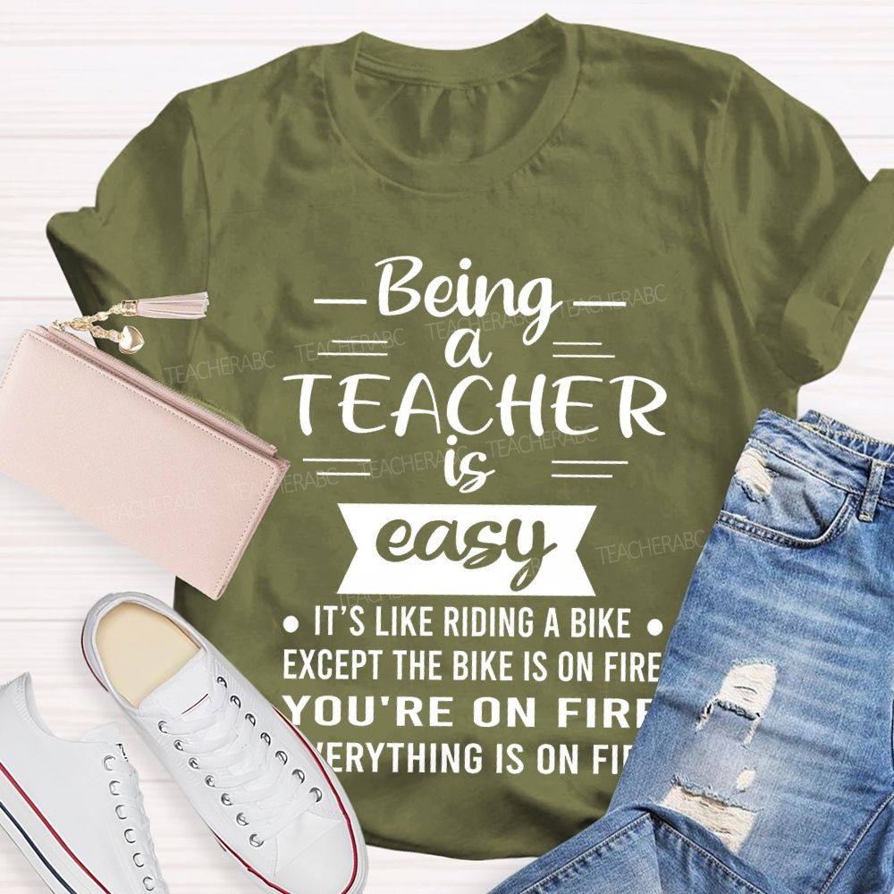 Being A Teacher Is Easy It's Like Riding A Bike Except The Bike Is On Fire Teacher T-shirt