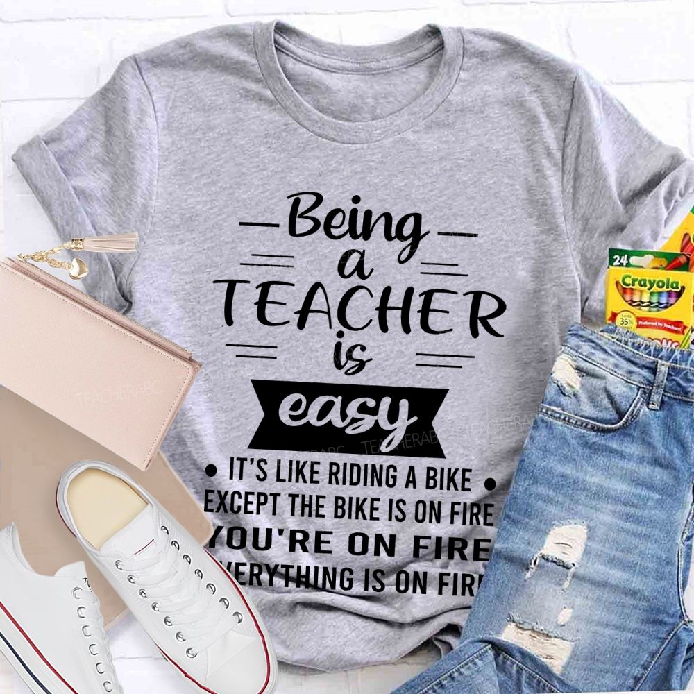 Being A Teacher Is Easy It's Like Riding A Bike Except The Bike Is On Fire Teacher T-shirt
