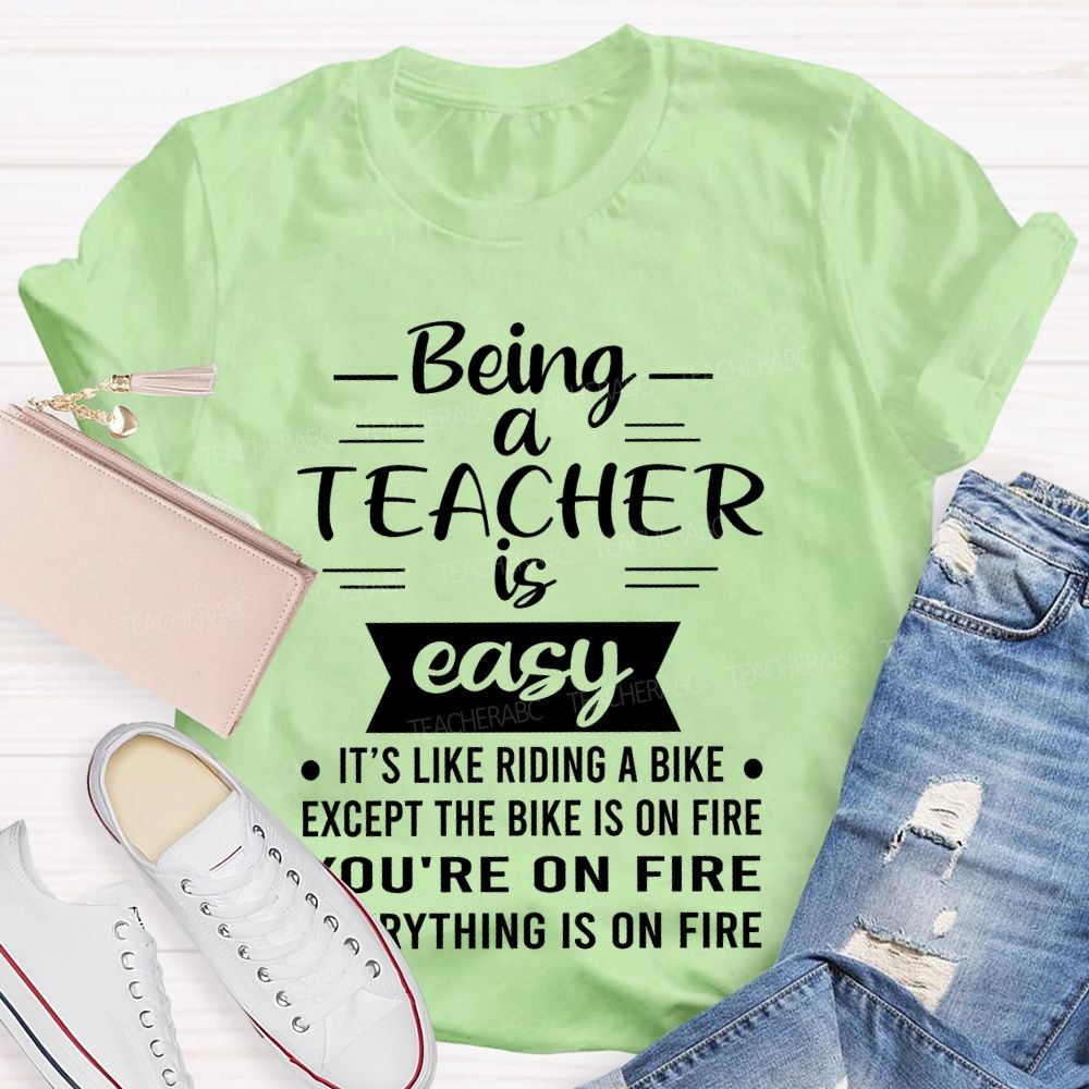 Being A Teacher Is Easy It's Like Riding A Bike Except The Bike Is On Fire Teacher T-shirt