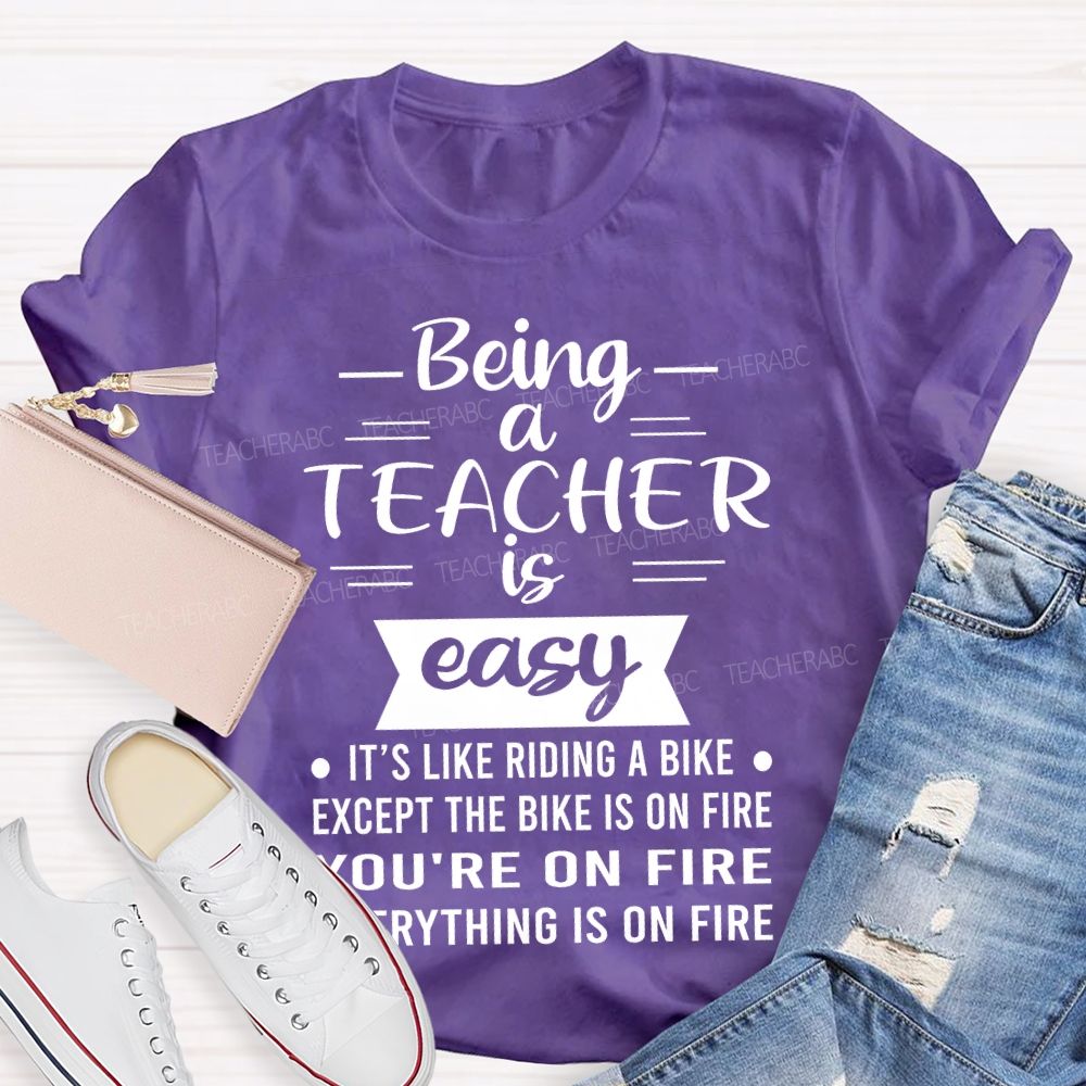 Being A Teacher Is Easy It's Like Riding A Bike Except The Bike Is On Fire Teacher T-shirt