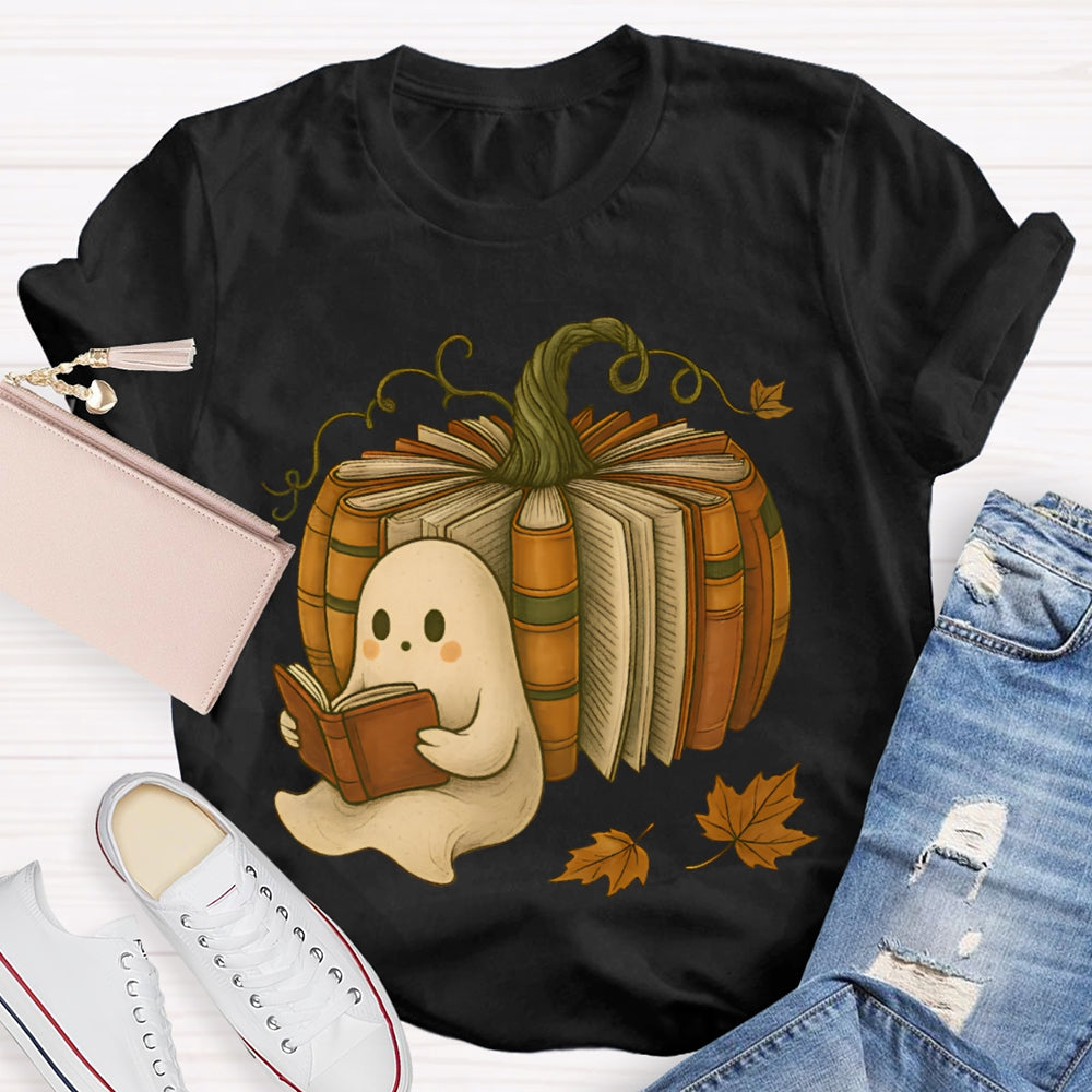 The Little Ghost Reading A Book Leans Against The Pumpkin T-shirt
