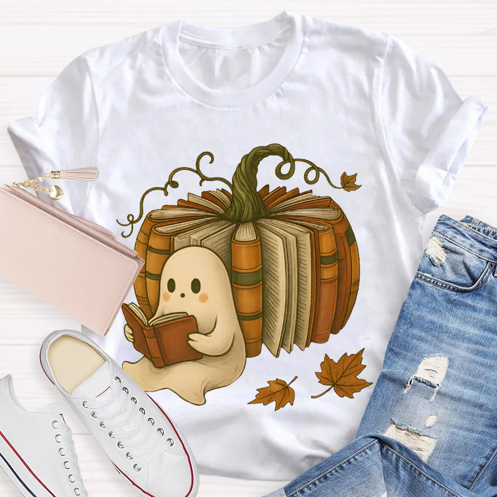 The Little Ghost Reading A Book Leans Against The Pumpkin T-shirt