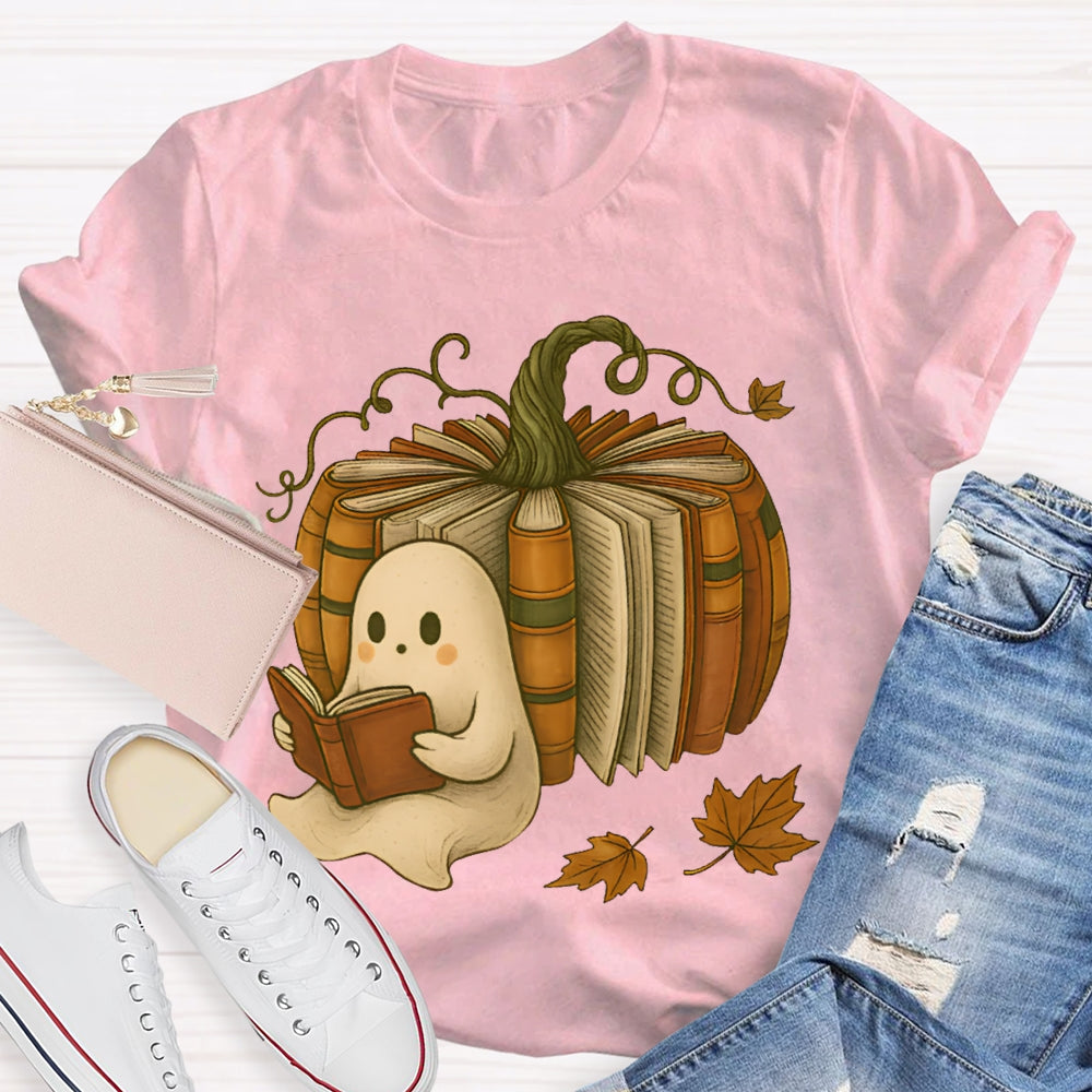The Little Ghost Reading A Book Leans Against The Pumpkin T-shirt