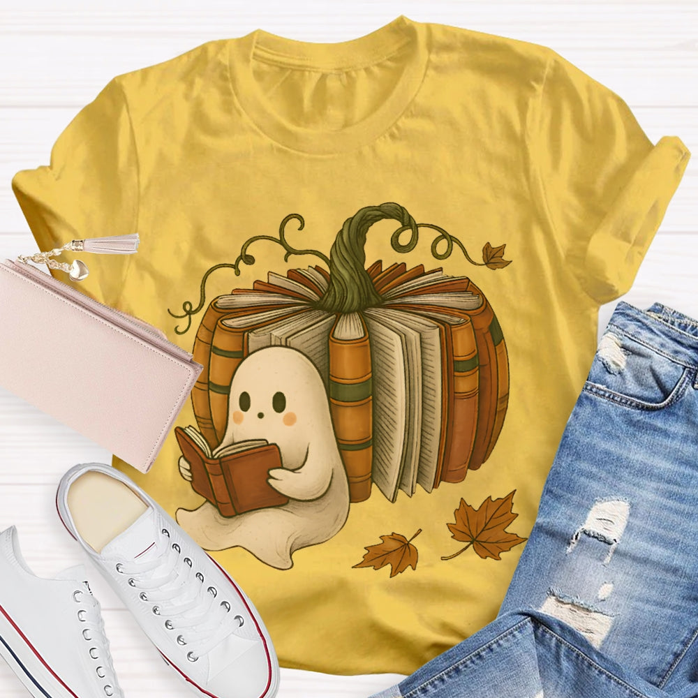 The Little Ghost Reading A Book Leans Against The Pumpkin T-shirt