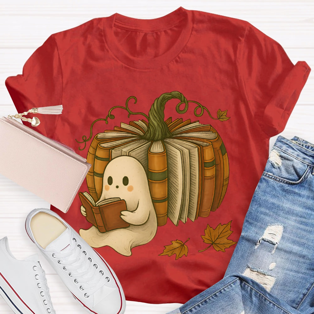 The Little Ghost Reading A Book Leans Against The Pumpkin T-shirt