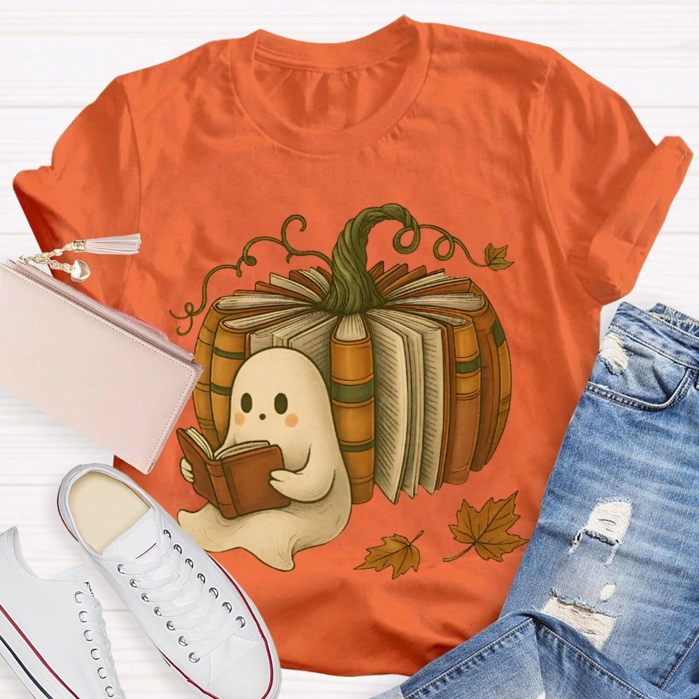 The Little Ghost Reading A Book Leans Against The Pumpkin T-shirt
