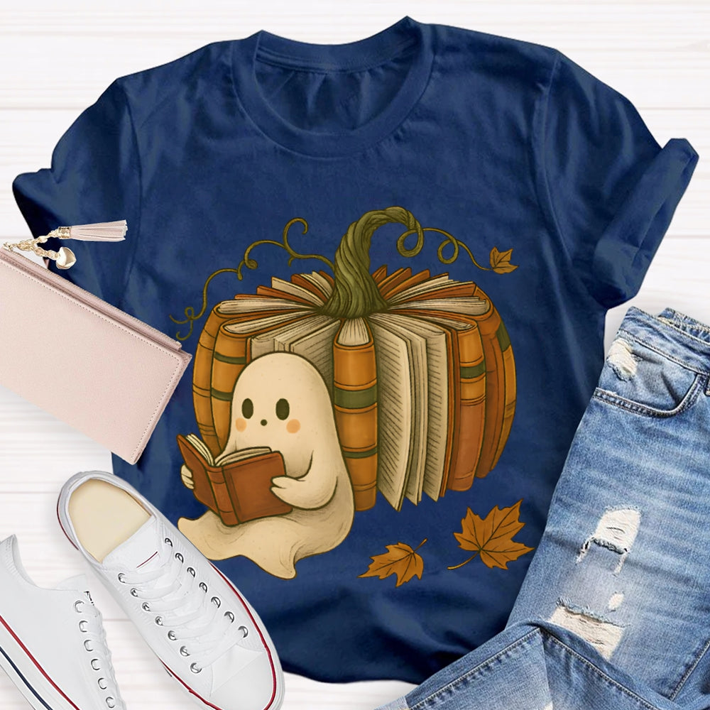 The Little Ghost Reading A Book Leans Against The Pumpkin T-shirt