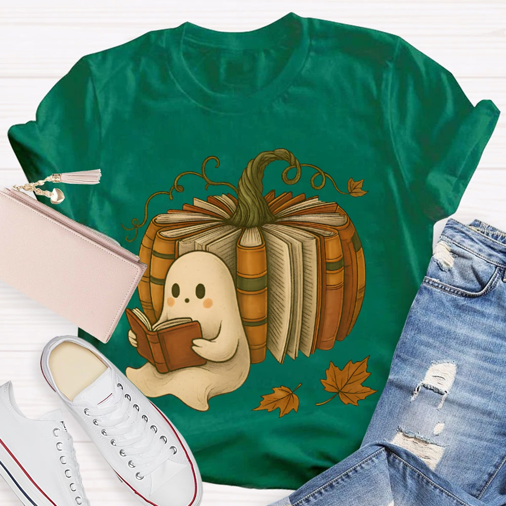 The Little Ghost Reading A Book Leans Against The Pumpkin T-shirt