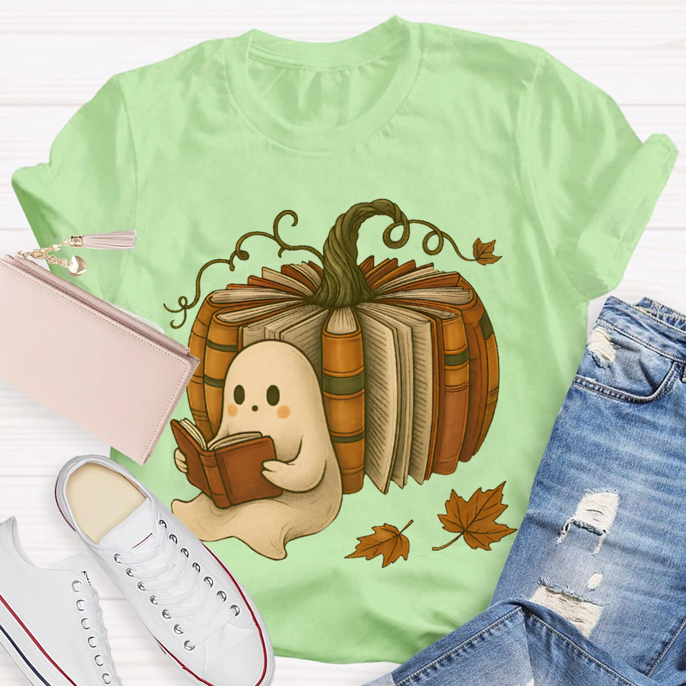 The Little Ghost Reading A Book Leans Against The Pumpkin T-shirt