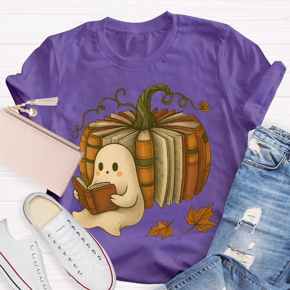 The Little Ghost Reading A Book Leans Against The Pumpkin T-shirt