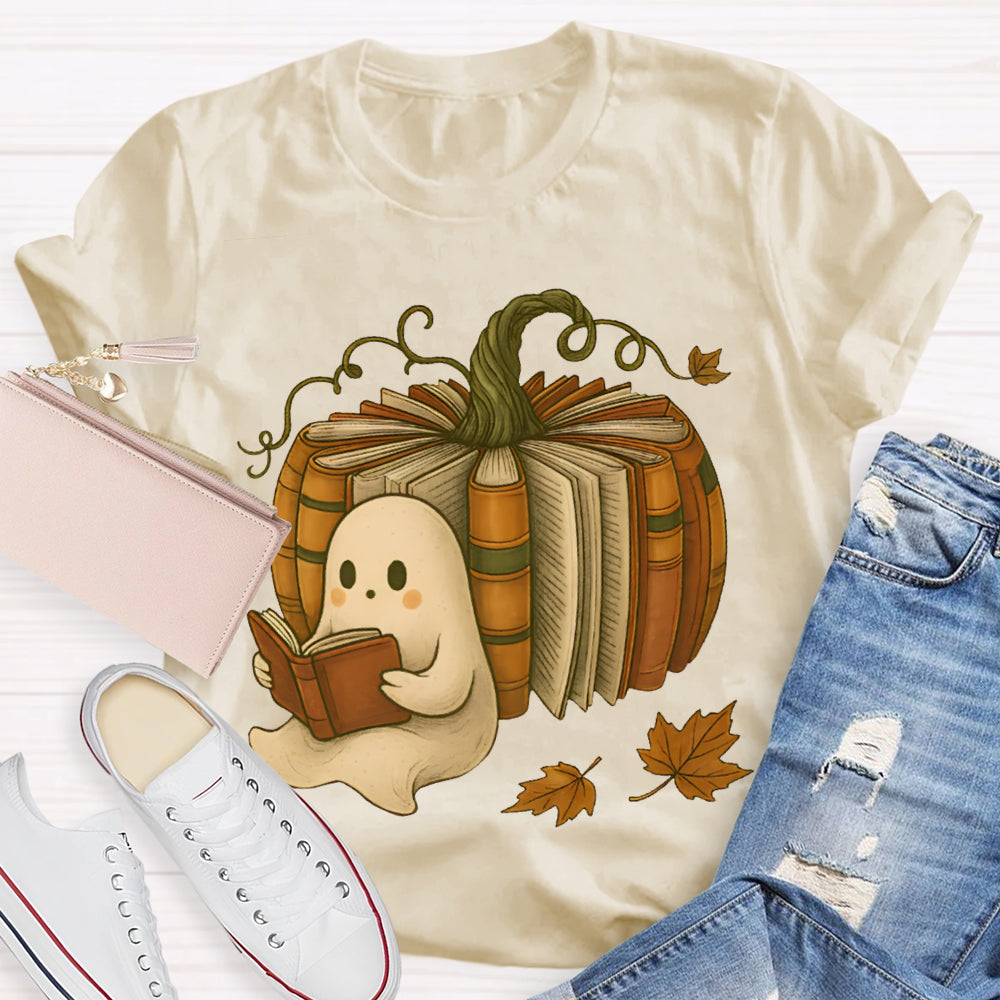 The Little Ghost Reading A Book Leans Against The Pumpkin T-shirt