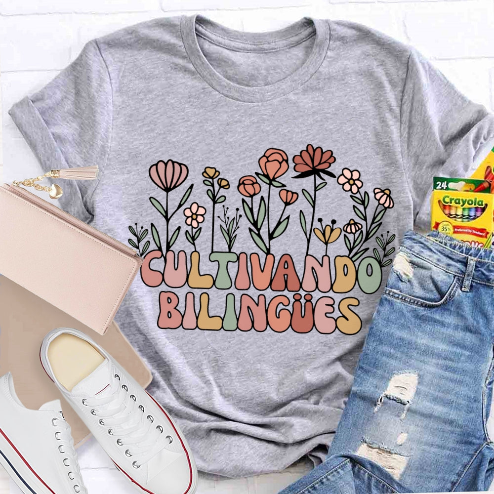Cultivando Bilingues Colorful Fonts And Small Flowers Bilingual Teacher T-shirt