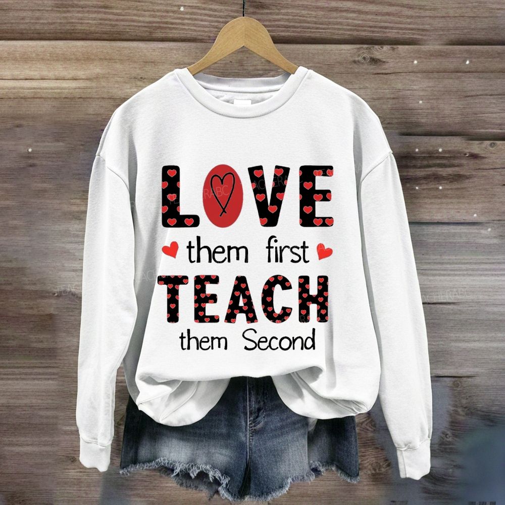 Red Heart Love Them First Teach Them Second Sweatshirt