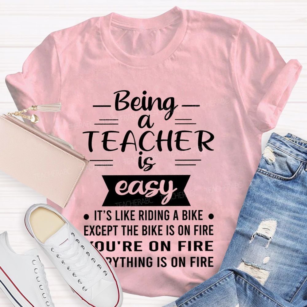 Being A Teacher Is Easy It's Like Riding A Bike Except The Bike Is On Fire  Teacher T-shirt
