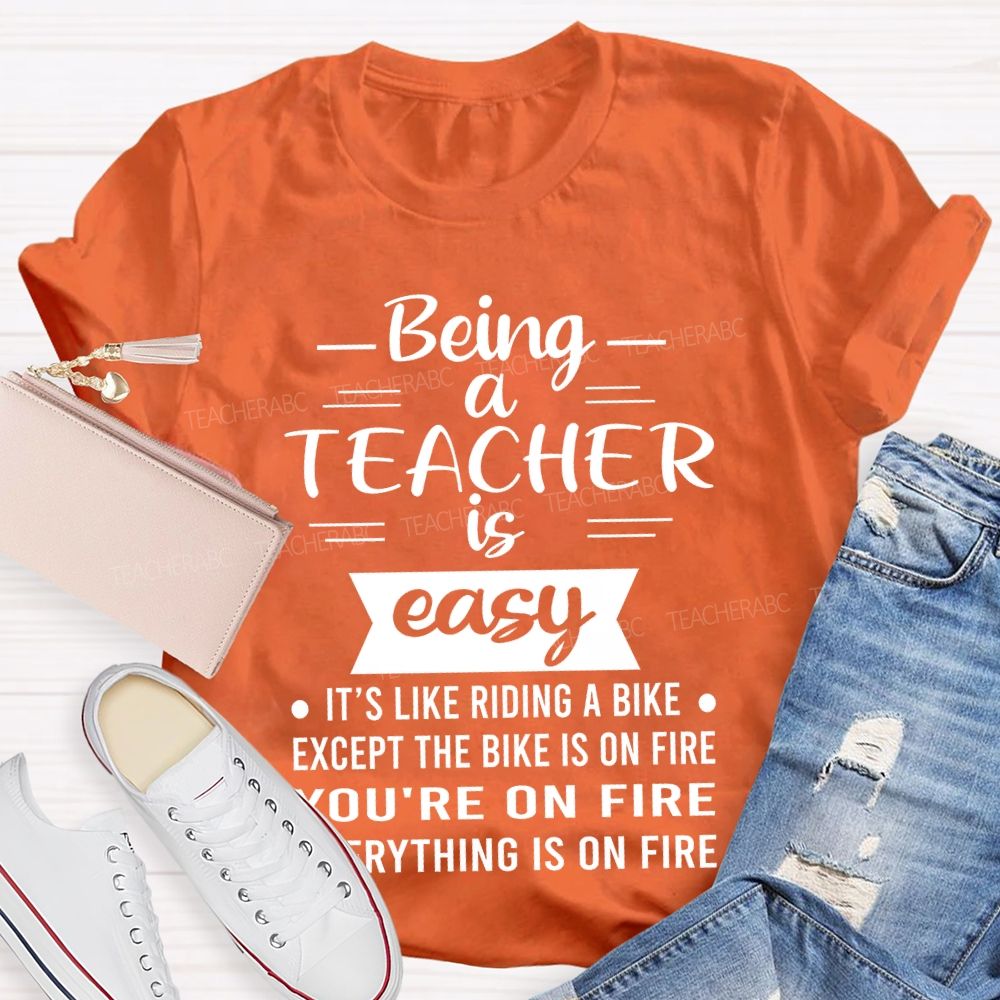 Being A Teacher Is Easy It's Like Riding A Bike Except The Bike Is On Fire  Teacher T-shirt