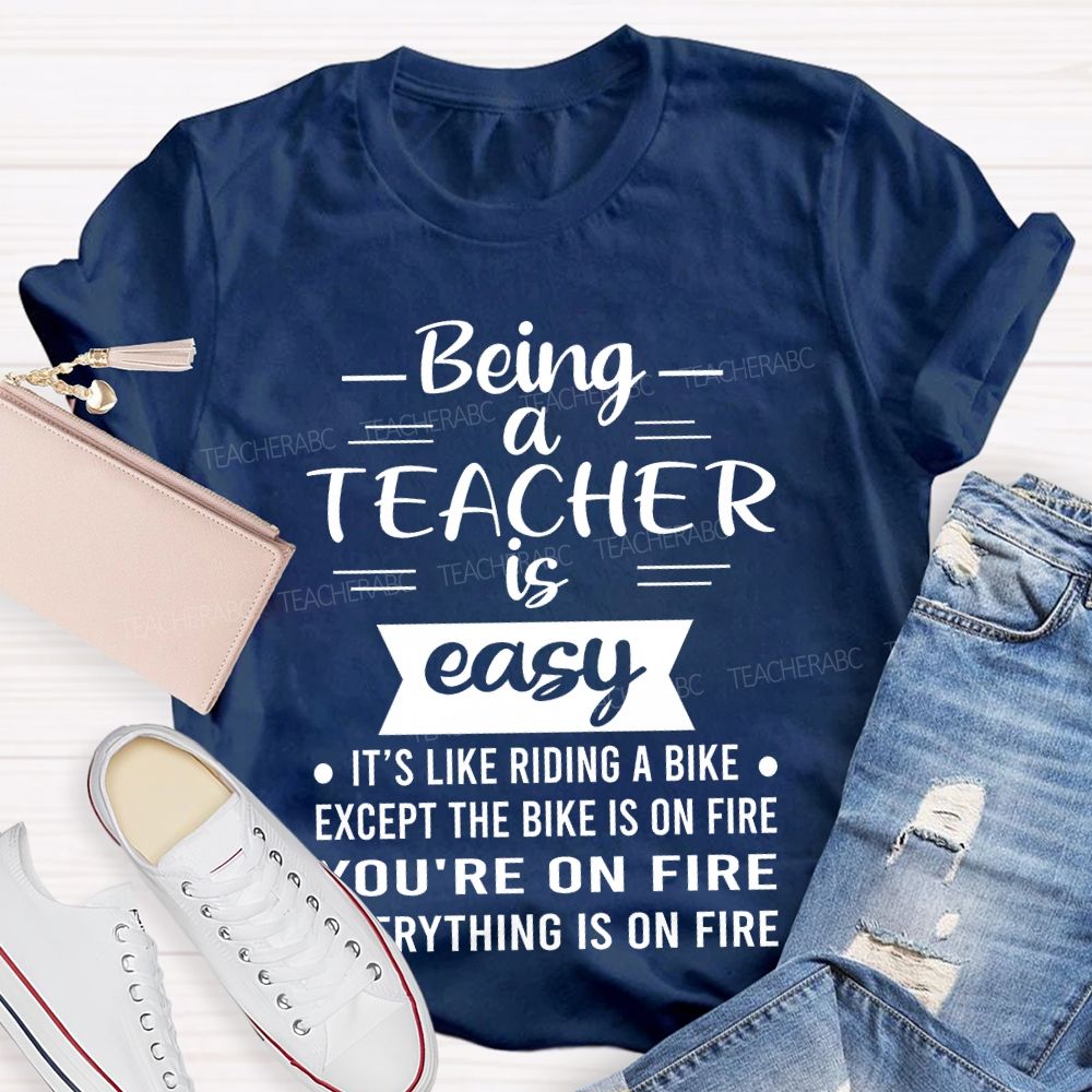 Being A Teacher Is Easy It's Like Riding A Bike Except The Bike Is On Fire  Teacher T-shirt