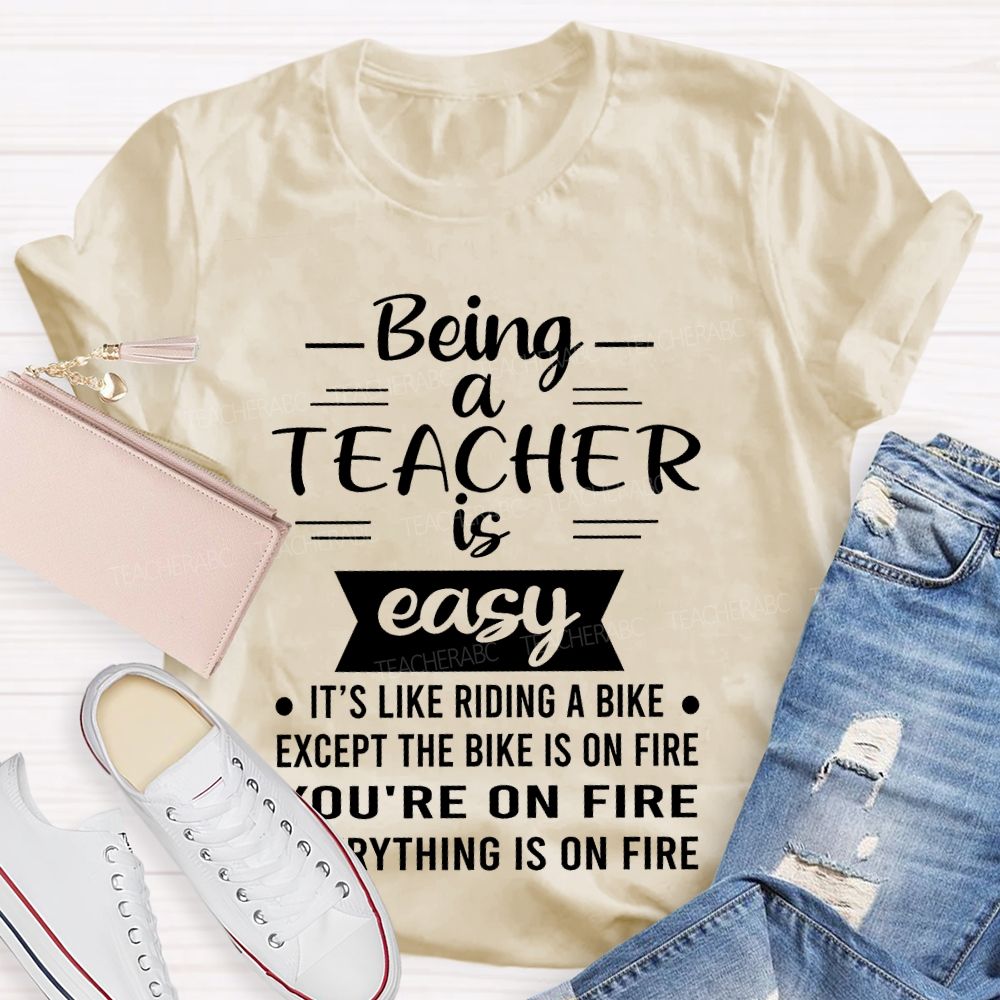 Being A Teacher Is Easy It's Like Riding A Bike Except The Bike Is On Fire  Teacher T-shirt