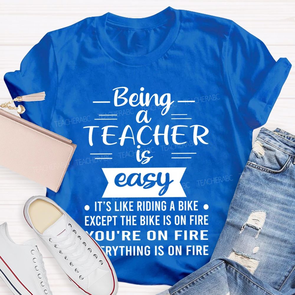 Being A Teacher Is Easy It's Like Riding A Bike Except The Bike Is On Fire  Teacher T-shirt
