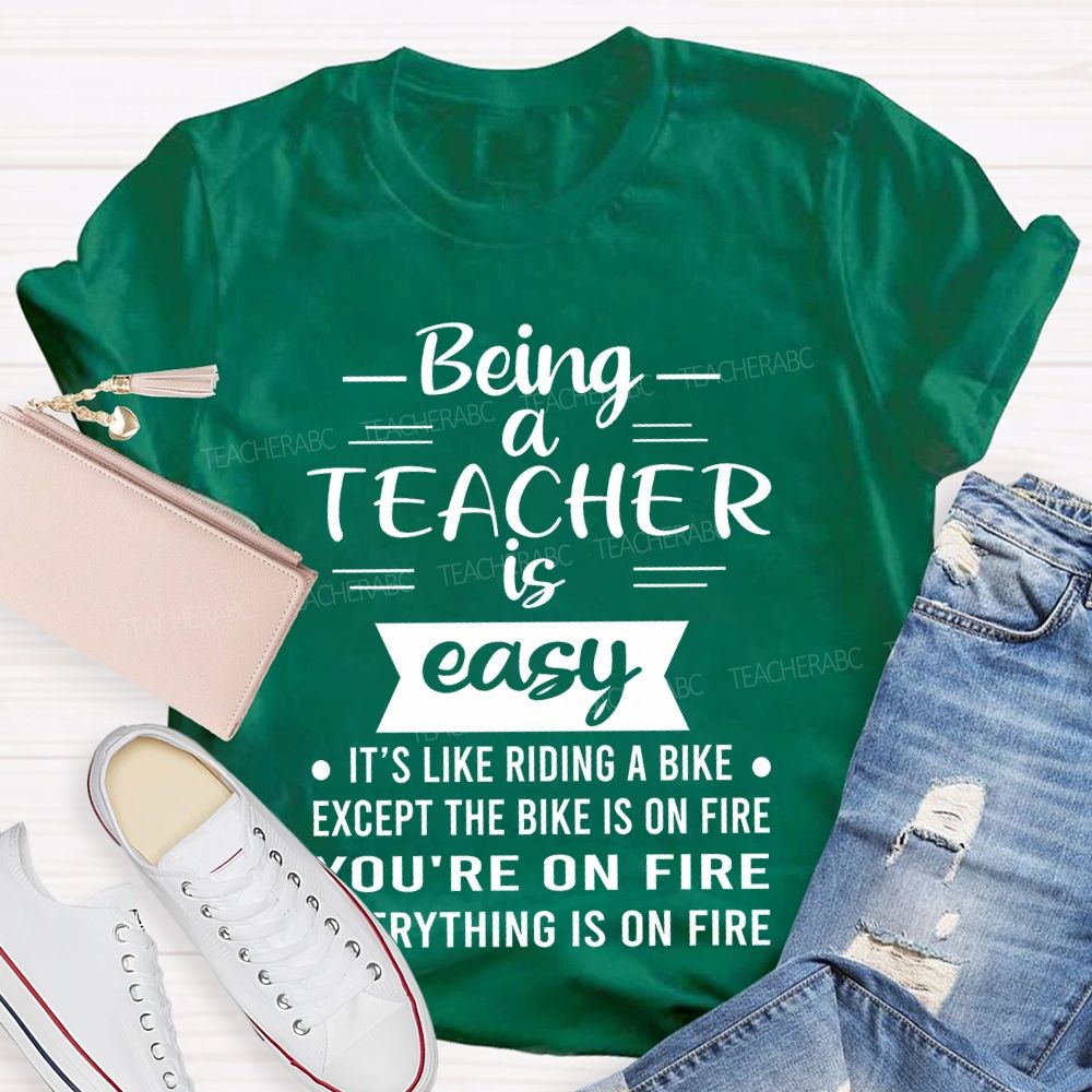 Being A Teacher Is Easy It's Like Riding A Bike Except The Bike Is On Fire  Teacher T-shirt